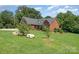 Beautiful brick home with an expansive front lawn and mature trees at 600 Old Hardin Rd, Dallas, NC 28034