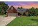 Charming brick home with well-manicured lawn and attached two-car garage at 600 Old Hardin Rd, Dallas, NC 28034