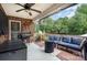 Covered patio with a brick wall, grill, and blue cushioned seating at 600 Old Hardin Rd, Dallas, NC 28034