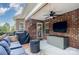 Covered patio with seating, a tv, a gas burning fireplace, and grill at 600 Old Hardin Rd, Dallas, NC 28034