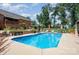 A backyard pool with surrounding furniture, landscaping and privacy fence at 600 Old Hardin Rd, Dallas, NC 28034