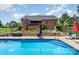 Backyard pool with a brick home, landscaping, and patio furniture at 600 Old Hardin Rd, Dallas, NC 28034