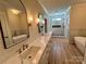 Luxurious bathroom with soaking tub, dual vanities, quartz countertops, and tiled shower at 603 Turnberry Ct, Albemarle, NC 28001