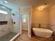 Elegant bathroom with a modern shower and soaking tub with tile surround at 603 Turnberry Ct, Albemarle, NC 28001