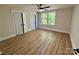 Bedroom with wood-look floors, a ceiling fan, and a double closet at 603 Turnberry Ct, Albemarle, NC 28001