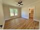 Spacious bedroom features wood-look floors, a ceiling fan, and a walk-in closet at 603 Turnberry Ct, Albemarle, NC 28001