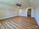 Bright bedroom featuring natural light, with wood-look flooring, and a modern ceiling fan at 603 Turnberry Ct, Albemarle, NC 28001