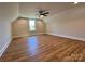 Spacious bedroom with natural light, wood-look flooring and a modern ceiling fan at 603 Turnberry Ct, Albemarle, NC 28001