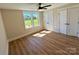 Bright bedroom featuring natural light, a ceiling fan, and beautiful wood-look flooring at 603 Turnberry Ct, Albemarle, NC 28001