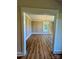 Formal dining room featuring wainscotting, hardwood floors, and modern chandelier at 603 Turnberry Ct, Albemarle, NC 28001