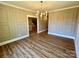 Bright dining room featuring wood-look floors, modern chandelier, and an open layout at 603 Turnberry Ct, Albemarle, NC 28001