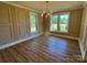 This dining room features an elegant chandelier, hardwood floors, and plenty of natural light at 603 Turnberry Ct, Albemarle, NC 28001