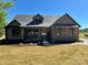 Charming single-story brick home with a covered front porch and professionally landscaped yard at 603 Turnberry Ct, Albemarle, NC 28001