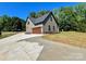 Exterior view of a modern home with a driveway, grassy lawn and attractive landscaping at 603 Turnberry Ct, Albemarle, NC 28001