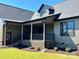 Exterior view of a modern home with a covered porch and manicured landscaping at 603 Turnberry Ct, Albemarle, NC 28001