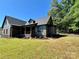 Beautiful exterior view of a modern home with a lush green lawn and mature trees at 603 Turnberry Ct, Albemarle, NC 28001