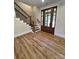 Welcoming foyer with beautiful hardwood floors, staircase, and a stylish glass paneled front door at 603 Turnberry Ct, Albemarle, NC 28001