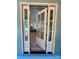 Elegant glass front door opens to reveal a bright and airy interior with hardwood floors at 603 Turnberry Ct, Albemarle, NC 28001