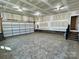 Spacious garage with a concrete floor, a rolling garage door, and ample lighting at 603 Turnberry Ct, Albemarle, NC 28001