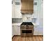The kitchen boasts a stainless steel stove, designer backsplash, and custom hood at 603 Turnberry Ct, Albemarle, NC 28001