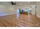 Open concept living space blending a living room and kitchen, enhanced by stylish hardwood floors at 603 Turnberry Ct, Albemarle, NC 28001