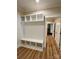 Hallway mudroom features custom shelving, storage, and wood-look floors at 603 Turnberry Ct, Albemarle, NC 28001
