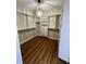 Custom walk-in closet with shelving and wood-look floors at 603 Turnberry Ct, Albemarle, NC 28001