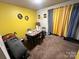 Dining area with yellow walls, table, chairs, and black and white checkered curtains at 6134 Bent Tree Ct, Charlotte, NC 28212