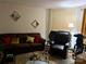 Living room with couch, recliner, glass coffee table, and wall decor at 6134 Bent Tree Ct, Charlotte, NC 28212