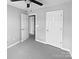 Neutral bedroom featuring neutral carpet and white doors leading to closets and other rooms at 6457 Saint Bernard Way, Charlotte, NC 28269