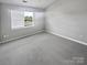 Inviting bedroom with plush carpet and a window offering plenty of natural light at 6457 Saint Bernard Way, Charlotte, NC 28269