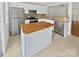 Charming kitchen with stainless steel appliances, tile backsplash, and a butcher block island at 6457 Saint Bernard Way, Charlotte, NC 28269