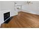 Spacious living room with hardwood floors, fireplace and staircase access to the kitchen at 6457 Saint Bernard Way, Charlotte, NC 28269