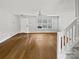 Bright living room features hardwood floors, a ceiling fan, and a window with natural light at 6457 Saint Bernard Way, Charlotte, NC 28269