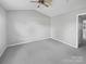 Spacious bedroom with soft carpet, neutral walls, and a ceiling fan at 6457 Saint Bernard Way, Charlotte, NC 28269
