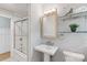 Bathroom featuring a glass enclosed shower, pedestal sink, and classic fixtures at 6609 Pleasant Dr, Charlotte, NC 28211