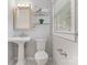 This bathroom features a pedestal sink, a window, and classic fixtures at 6609 Pleasant Dr, Charlotte, NC 28211