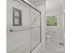 Modern bathroom with glass-enclosed shower, subway tile, mosaic accents, and patterned tile flooring at 6609 Pleasant Dr, Charlotte, NC 28211