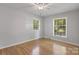 This bedroom has hardwood floors and two windows at 6609 Pleasant Dr, Charlotte, NC 28211