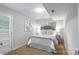 A charming bedroom with neutral walls, and a beautifully designed headboard and side tables at 6609 Pleasant Dr, Charlotte, NC 28211