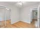 Bright bedroom with hardwood floors and mirrored closet, offering a comfortable and functional space at 6609 Pleasant Dr, Charlotte, NC 28211