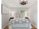 This bedroom features a bed with an upholstered headboard and a ceiling fan at 6609 Pleasant Dr, Charlotte, NC 28211