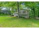 Beautifully landscaped front yard with mature trees surrounding this gray, two-story home at 6609 Pleasant Dr, Charlotte, NC 28211