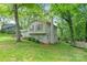 Two story home with a brick chimney, manicured lawn, and mature trees at 6609 Pleasant Dr, Charlotte, NC 28211
