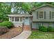 Charming home featuring a light blue front door, a landscaped yard, and a gray painted brick front at 6609 Pleasant Dr, Charlotte, NC 28211