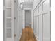 Bright hallway featuring hardwood floors, white wainscoting, and recessed lighting for a clean aesthetic at 6609 Pleasant Dr, Charlotte, NC 28211