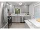 Modern kitchen with stainless steel appliances, white subway tile backsplash, and marble countertops for a sleek look at 6609 Pleasant Dr, Charlotte, NC 28211