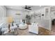 Bright living room featuring modern decor, a ceiling fan, and hardwood floors at 6609 Pleasant Dr, Charlotte, NC 28211