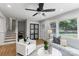 Bright living room with hardwood floors, comfortable seating, and a view of the staircase at 6609 Pleasant Dr, Charlotte, NC 28211