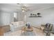 Comfortable living room featuring a cozy seating area and a decorative shelf, perfect for relaxation at 6609 Pleasant Dr, Charlotte, NC 28211